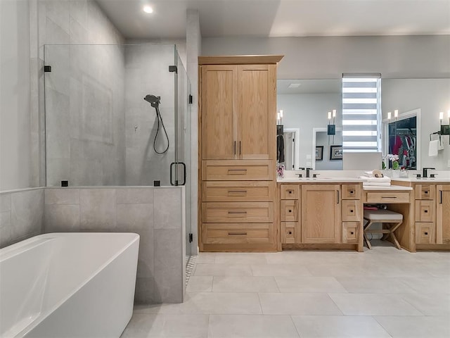 bathroom featuring tile patterned floors, vanity, and shower with separate bathtub