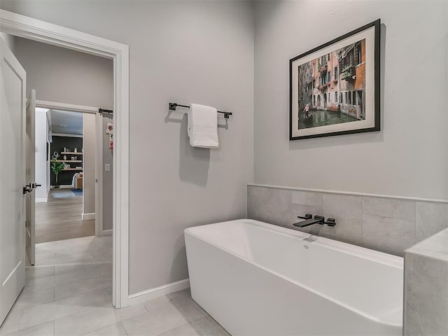 bathroom with tile patterned floors and a bathtub