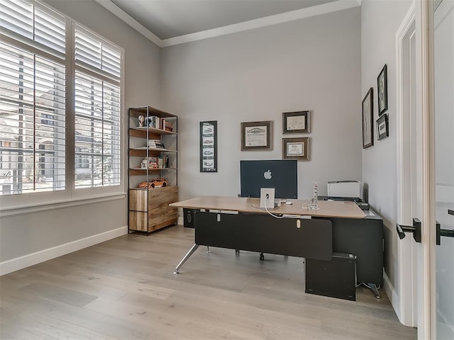 office space with ornamental molding and light wood-type flooring