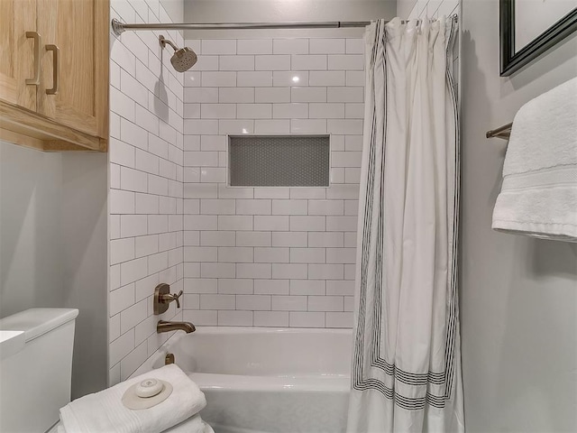 bathroom with toilet and shower / bath combo with shower curtain