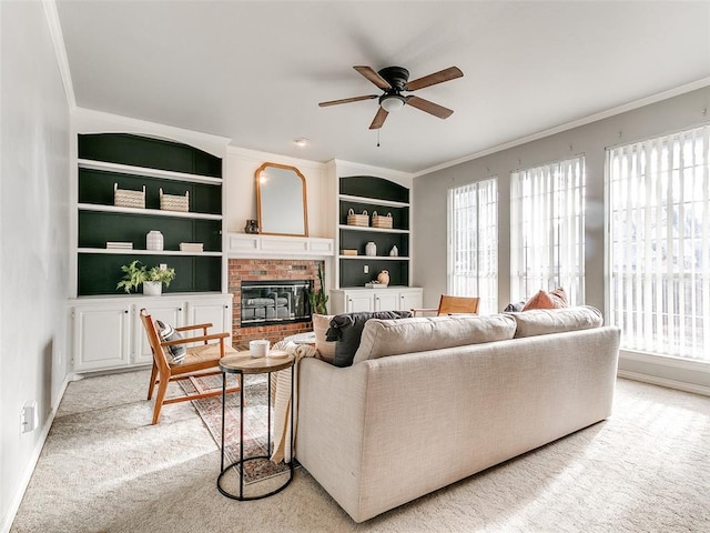 living room with built in shelves, light colored carpet, crown molding, and a brick fireplace