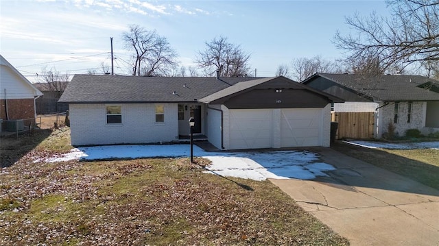 single story home with central AC and a garage