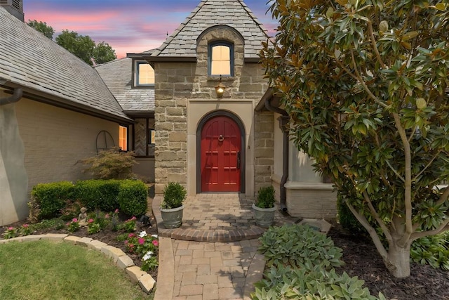 view of exterior entry at dusk