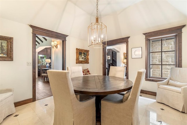 tiled dining space with a chandelier