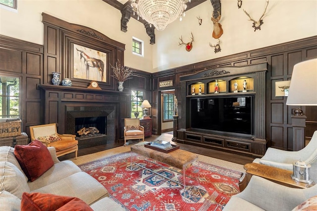 living room featuring hardwood / wood-style floors, a chandelier, and a high ceiling