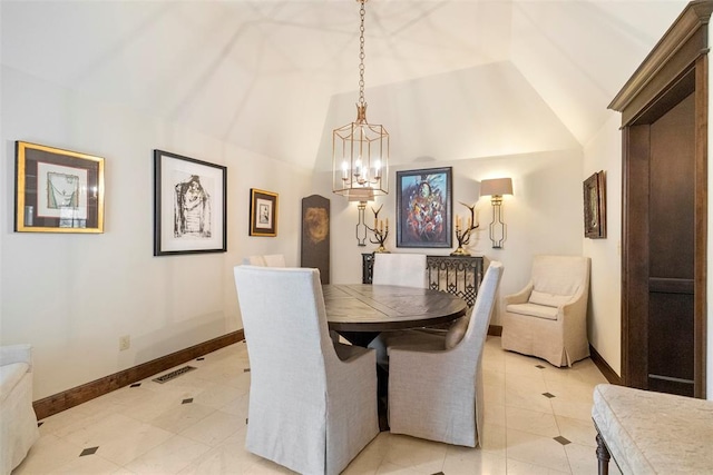 dining space featuring a notable chandelier, light tile patterned floors, and lofted ceiling