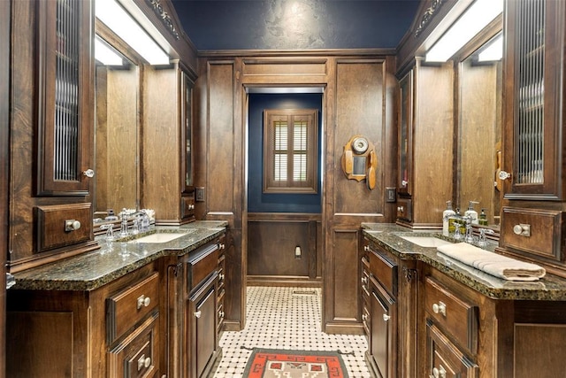 bathroom featuring wooden walls and vanity