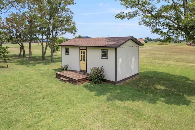 view of outdoor structure featuring a lawn