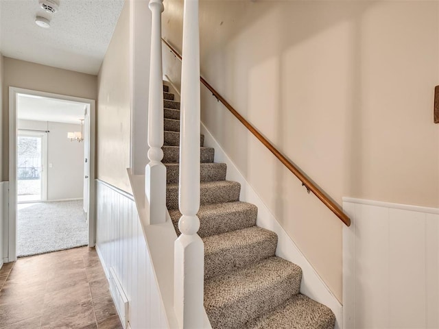 staircase featuring carpet