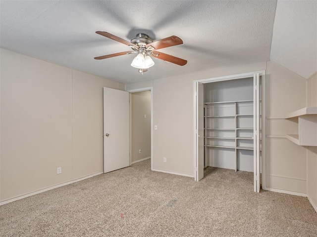 unfurnished bedroom featuring ceiling fan, light carpet, and a textured ceiling