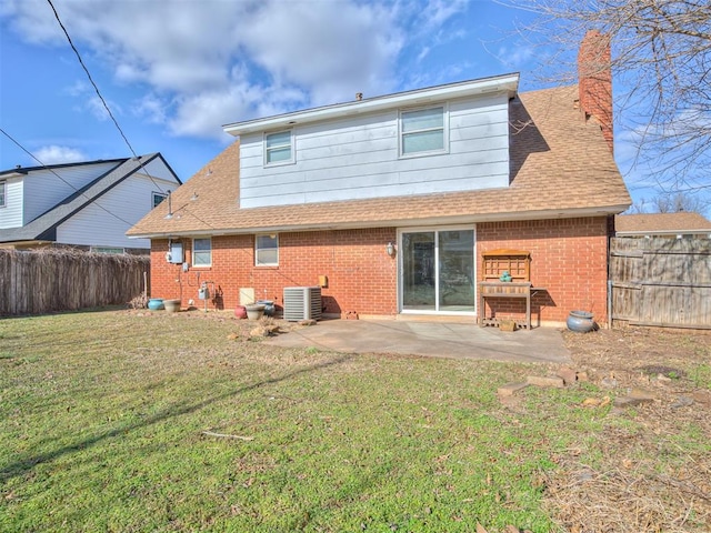 rear view of house featuring a lawn, a patio, and central air condition unit