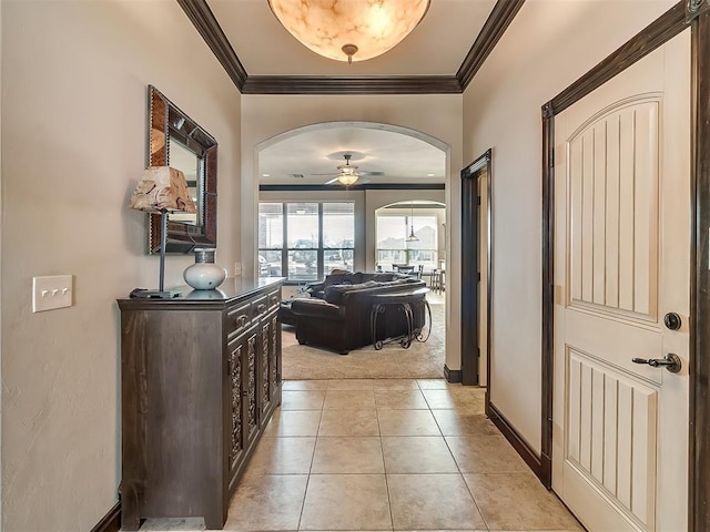 hall featuring crown molding and light tile patterned floors