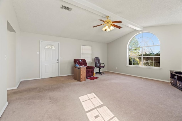 misc room featuring ceiling fan, light colored carpet, a textured ceiling, and vaulted ceiling with beams