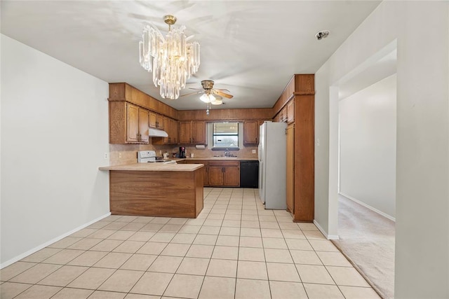 kitchen with ceiling fan with notable chandelier, sink, light colored carpet, kitchen peninsula, and white appliances