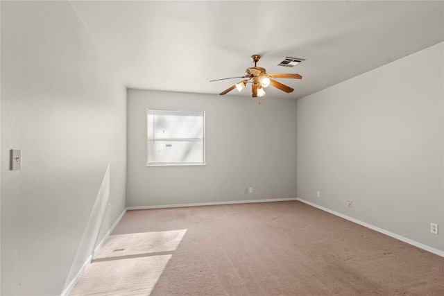 unfurnished room featuring light colored carpet and ceiling fan