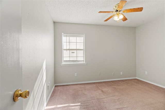 carpeted empty room with a textured ceiling and ceiling fan