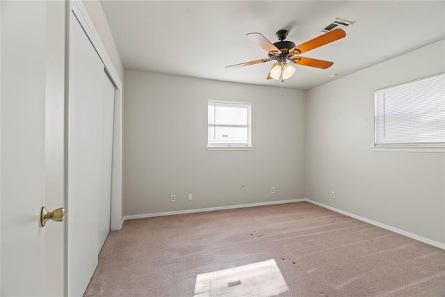 unfurnished bedroom featuring light colored carpet and ceiling fan