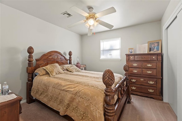 carpeted bedroom featuring ceiling fan and a closet