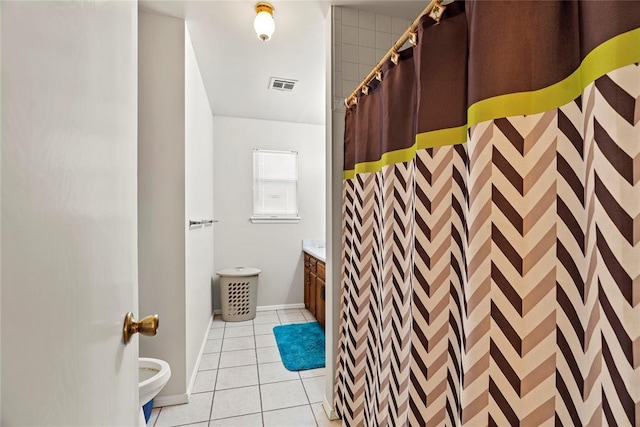 bathroom featuring walk in shower, vanity, and tile patterned flooring