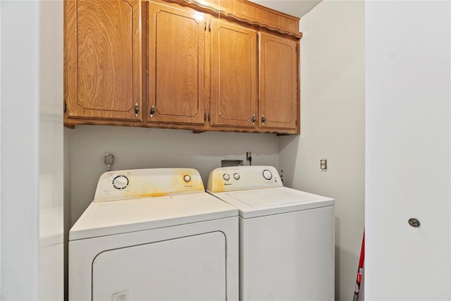 washroom with cabinets and separate washer and dryer