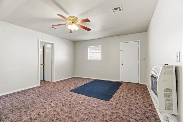 interior space with ceiling fan, carpet, and heating unit