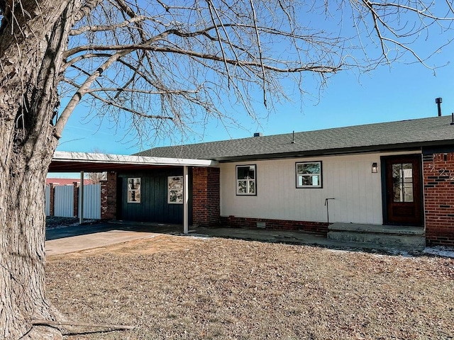 single story home featuring a carport