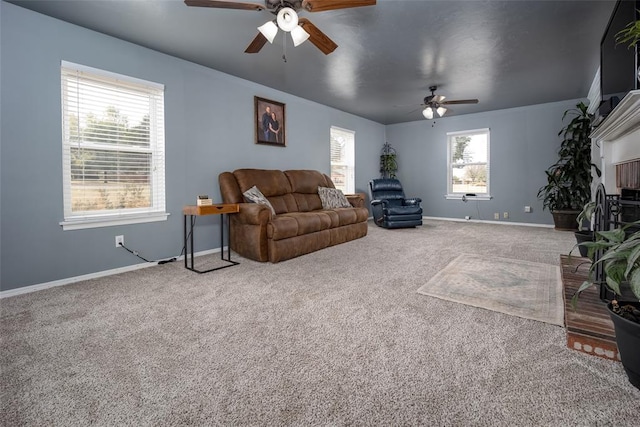 living room with ceiling fan, a wealth of natural light, and carpet flooring