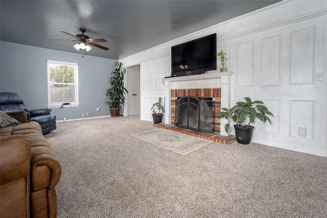 carpeted living room with ceiling fan and a brick fireplace