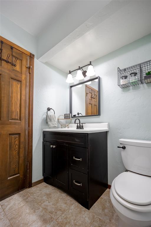 bathroom featuring toilet and vanity