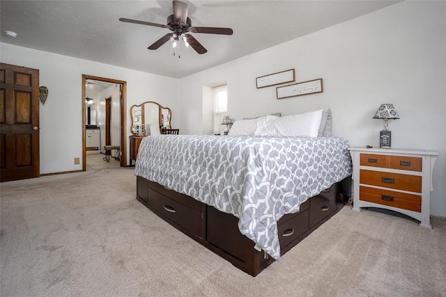 carpeted bedroom featuring ensuite bath and ceiling fan