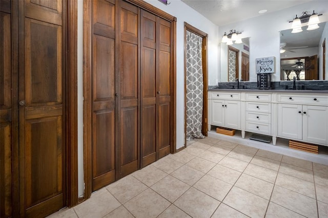 bathroom featuring ceiling fan, vanity, and tile patterned flooring