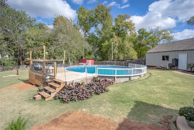 view of pool with a deck and a yard