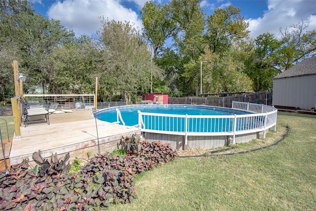 view of pool with an outdoor structure, a lawn, and a wooden deck