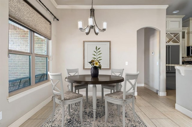 dining space featuring an inviting chandelier and crown molding