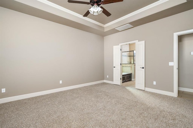 unfurnished bedroom with crown molding, light colored carpet, a raised ceiling, and ceiling fan