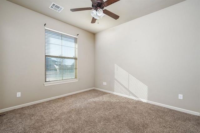 carpeted spare room with ceiling fan