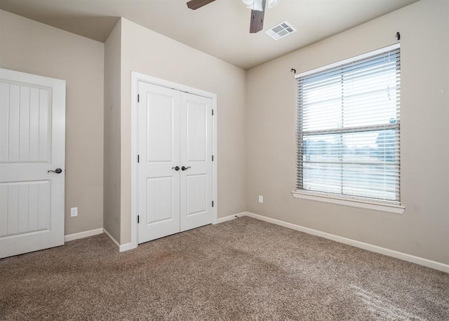 unfurnished bedroom featuring ceiling fan, carpet floors, and a closet