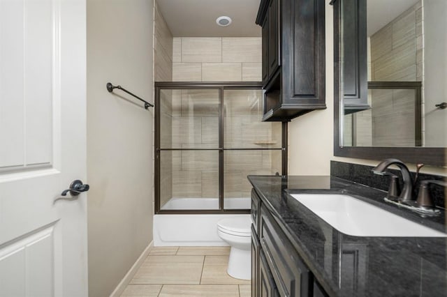 full bathroom featuring enclosed tub / shower combo, vanity, and toilet