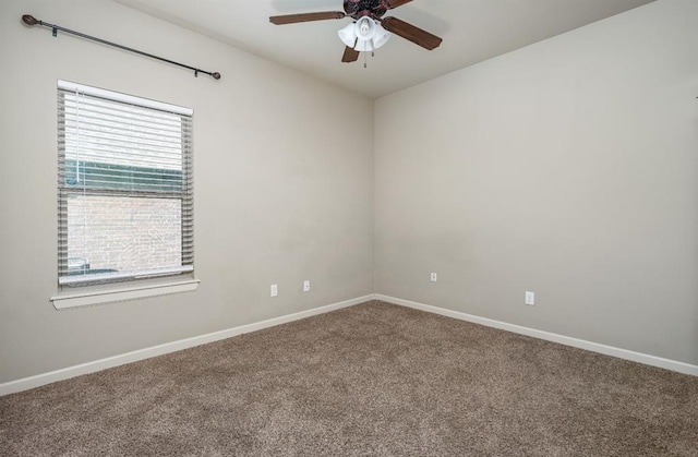 carpeted spare room featuring ceiling fan