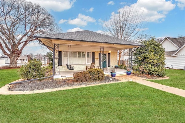 view of front of home with covered porch and a front yard