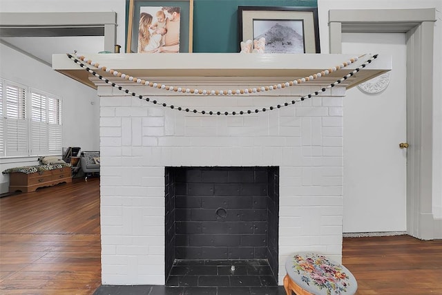 room details with hardwood / wood-style flooring and a fireplace