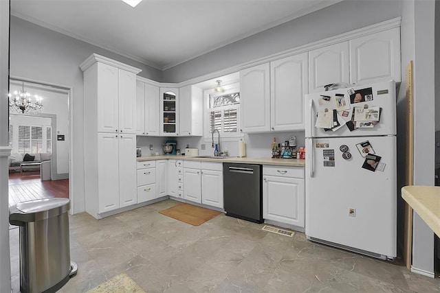 kitchen featuring white refrigerator, dishwasher, sink, and white cabinets