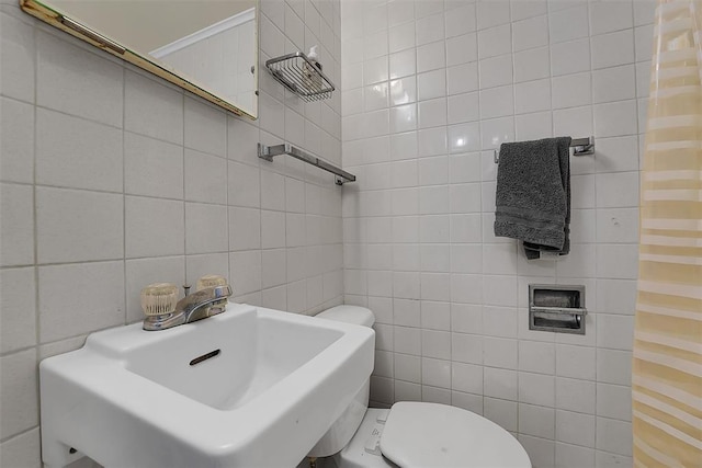 bathroom featuring tile walls, sink, and toilet