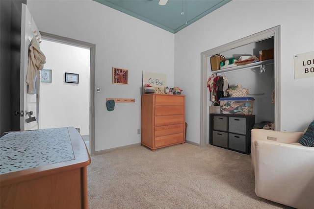 bedroom featuring light carpet and a closet