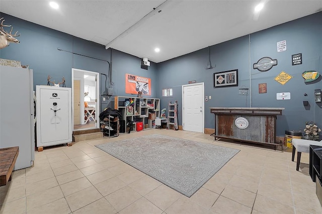 interior space featuring light tile patterned floors and a high ceiling