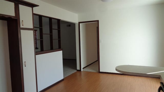 unfurnished room with light wood-type flooring