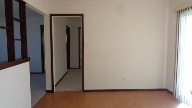 unfurnished room with light hardwood / wood-style floors