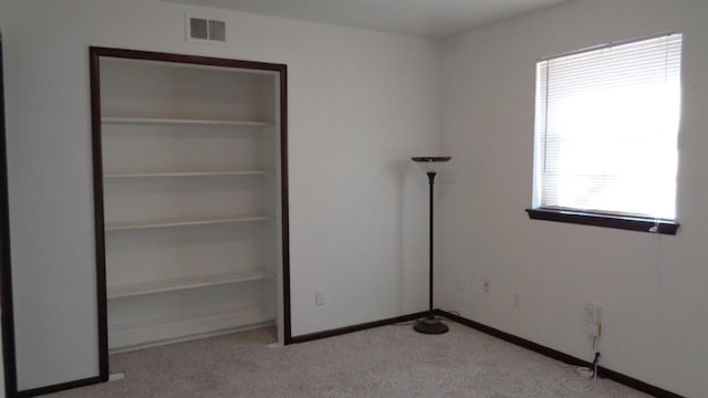 unfurnished bedroom featuring light carpet