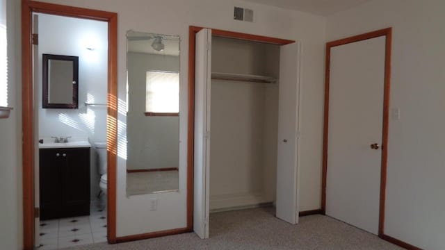 unfurnished bedroom featuring ensuite bath and sink