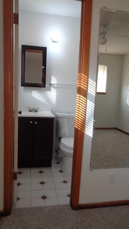 bathroom with ceiling fan, vanity, toilet, and tile patterned flooring